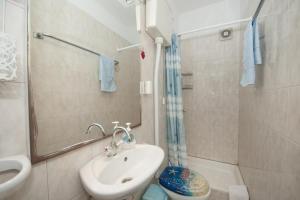 a bathroom with a sink and a toilet and a shower at Two Bedroom Apartment with Terrace A1 in Splitska +28 photos
