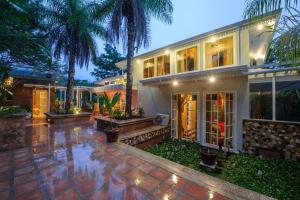 a house with palm trees in front of it at Villa Turrubares in San Pablo