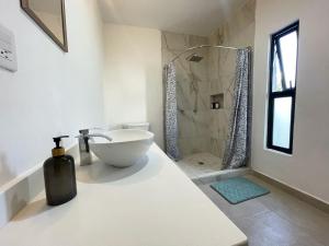 a white bathroom with a sink and a shower at Casa DOS21 Boutique Apartments Playa Sur in Mazatlán +70 photos
