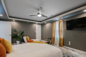 a bedroom with a large bed and a flat screen tv at Ellis Hideaway in Fayetteville
