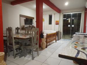 a living room with a table and a couch at Casa 23 Alto do Mucuge in Porto Seguro