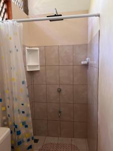 a bathroom with a shower with a shower curtain at Casa LORA Eco nature retreat in Bagaces in Bagaces +12 photos