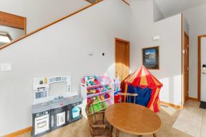 a kitchen with a table and a play tent at 1101 Mesa Drive: 2 in Silverthorne +31 photos