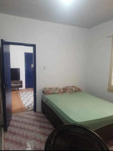 a bedroom with a bed in a room with a mirror at Casa Praia Grande in Arraial do Cabo