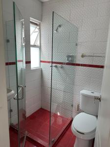 a bathroom with a toilet and a glass shower at Departamento Completo Centro Historico in Mexico City