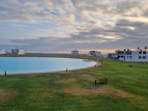 a large pool of water next to a building at Casa de Playa Luxury Laguna Azul Tacna in Tacna