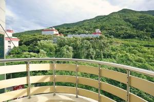 a balcony with a view of a mountain at Ulsan Yeongnam Alps Sandia Oncheon in Ulsan +5 photos