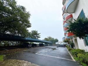 a parking lot with cars parked next to a building at Ulsan Yeongnam Alps Sandia Oncheon in Ulsan