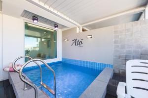a swimming pool in a room with a tub at Gangneung Atopool Villa in Gangneung