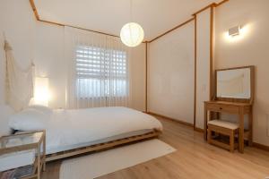 Una cama o camas en una habitación de Jeju Broccoli BNB