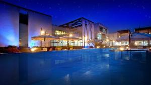 a building with a swimming pool at night at Bao House Pool Villa in Yangpyeong