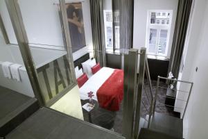 a hotel room with a bed with a red blanket at Van der Valk Hotel Hildesheim in Hildesheim