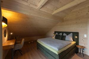 a bedroom with a bed and a desk in a room at Chalet Kremstalblick in Neuhofen an der Krems +36 photos