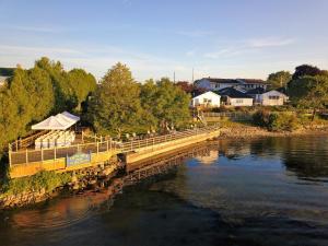 a bridge over a river with people sitting on it at Dewar’s Inn and Cottages in Prescott