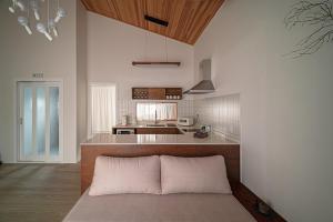 a kitchen with a bed in the middle of a room at Jeju Sinyeom-an-gil B in Jeju
