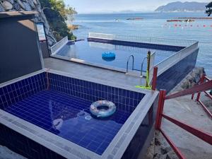 a swimming pool with a toilet in the water at Geumodo Joy Joy Pension in Yeosu