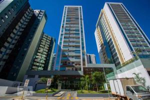two tall buildings with a truck in a city at Apto Completo Melhor Localização in Brasilia