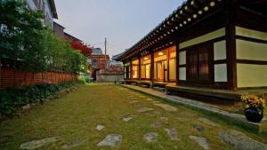 a courtyard of a building next to a building at Pungryuheon Hanok private house in Jeonju