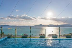 a swimming pool with a view of the water at Yeosu View21 Pension in Yeosu +11 photos