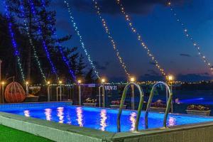 a swimming pool at night with christmas lights at Yeosu View21 Pension in Yeosu