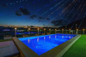 a large blue swimming pool at night with lights at Yeosu View21 Pension in Yeosu