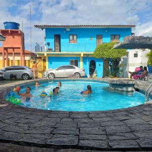 a group of people in a swimming pool at Casa na praia do bispo pa in Mosqueiro