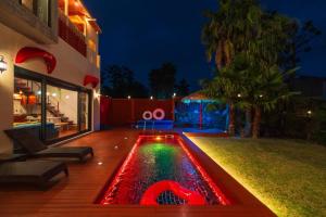 a pool in the yard of a house at night at Its you Pool Villa in Jeju