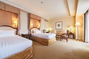 um quarto de hotel com duas camas e uma mesa em Hotel Grand Tiara Minaminagoya em Anjomachi