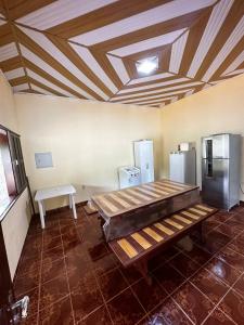 a room with two refrigerators and a bench in it at Casa com 3 quartos em Alter do Chão in Santarém