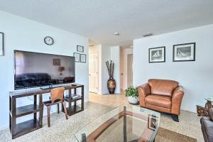 a living room with a tv and a couch and a chair at Satchell's Lakehouse in Inverness