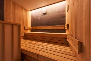 an empty sauna with a clock on the wall at Hotel Grand Tiara Minaminagoya in Anjomachi
