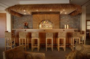 a bar in a resort with a stone wall at Hawaii Hotel in Marmaris