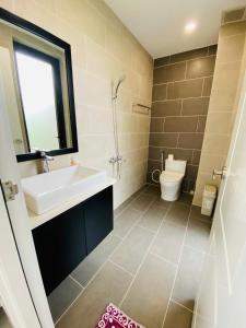 a bathroom with a sink and a toilet at Swanbay - Hà Hoàng Villa in Cù Lao Ong Con