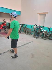 a boy wearing a helmet standing in front of a row of bikes at Precioso Duplex Cal Richi in Tremp