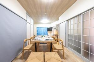 a dining room with a table and chairs at SORA usjまで電車で8分 5つの寝室 貸切の宿で楽しい時間を過ごしてください in Osaka