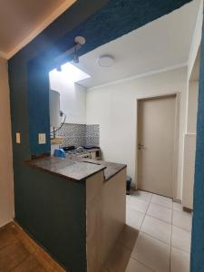 a kitchen with a counter and a blue wall at Compejo Aviv Centro 2 in La Rioja