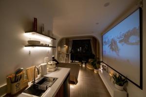 a kitchen with a large view of a living room at Aimee House Homestay Trấn Vũ in Hanoi