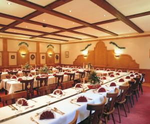 a banquet hall with long tables and chairs at Hotel Haus Rameil in Lennestadt