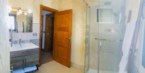 a bathroom with a glass shower and a sink at Apartment Alegria in the stunning Village of Mozaga, Lanzarote in Mozaga +28 photos