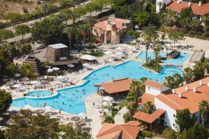 a beach filled with lots of palm trees at PortAventura Hotel El Paso - Includes PortAventura Park Tickets in Salou