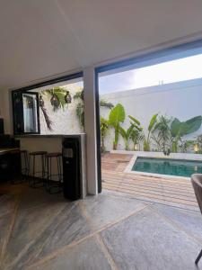 a house with a view of a swimming pool at Villa Kaia Canggu in Canggu