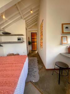 a bedroom with a bed and a table and a door at Villa Kaia Canggu in Canggu +10 photos
