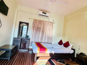 um quarto com uma cama, uma escrivaninha e uma janela em Hotel The Lake em Pokhara