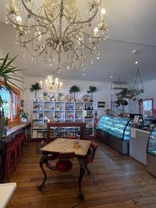 a room with a table and a bed and a chandelier at Apartment 88 in Greytown