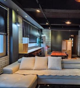 a living room with a couch and a table at Paju Sabai Pension in Paju