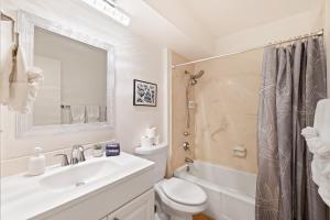 a bathroom with a sink and a toilet and a shower at Waikiki Ilikai Marina in Honolulu