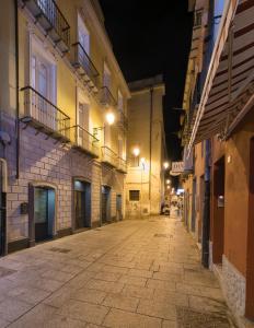 an empty street in an old town at night at Palazzo Dessy in Cagliari