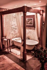 e bagno con vasca, lavandino e vasca. di The FarSide Country Manor a Nottingham Road