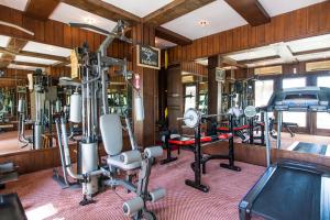 a gym with several tread machines and a treadmill at The Hotel by the Red Canal in Mandalay