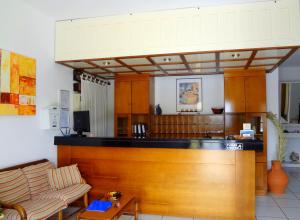 a kitchen with a wooden counter and a table at Blue Bay Hotel in Skala